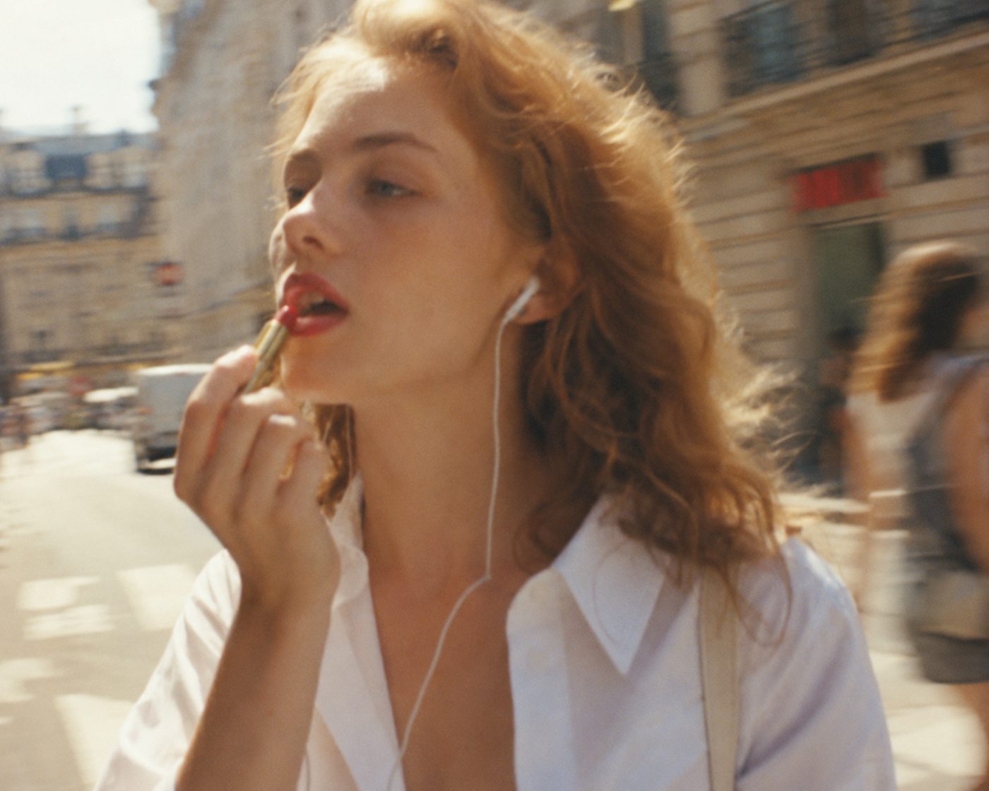 Applying lipstick on the street